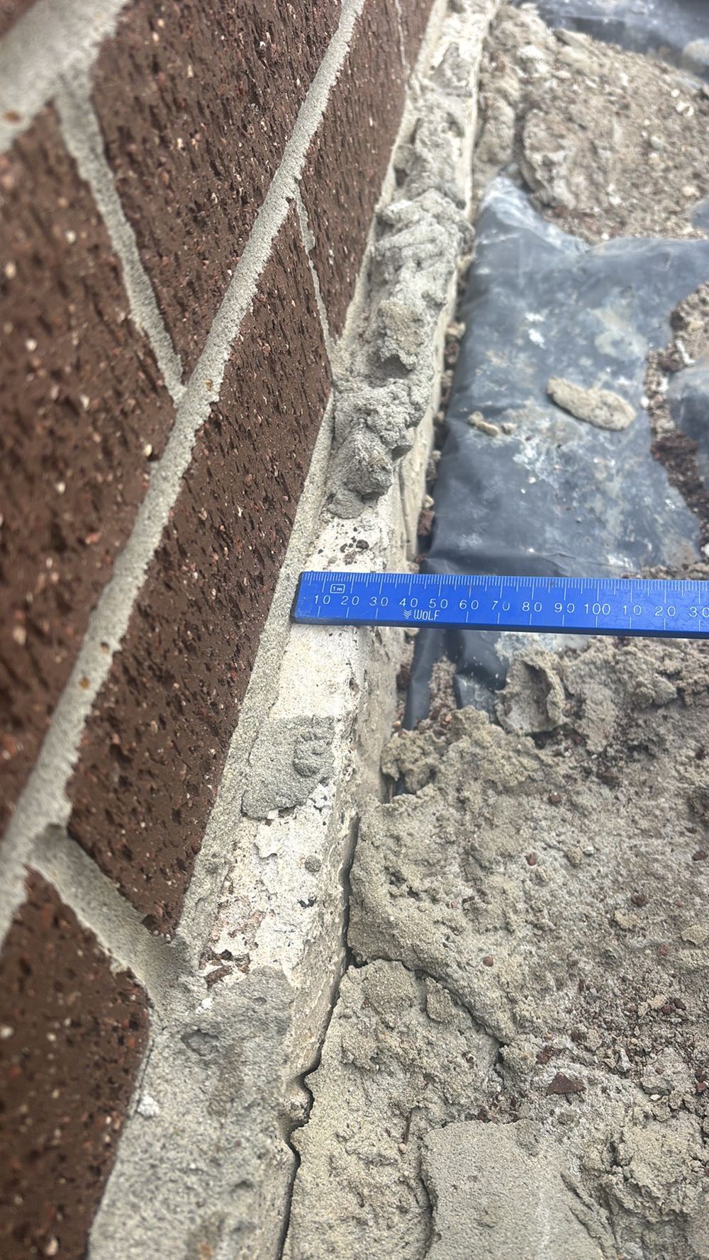 Slab edge projecting past the cladding face and needing trimming, found during a fixing inspection in Hoppers Crossing