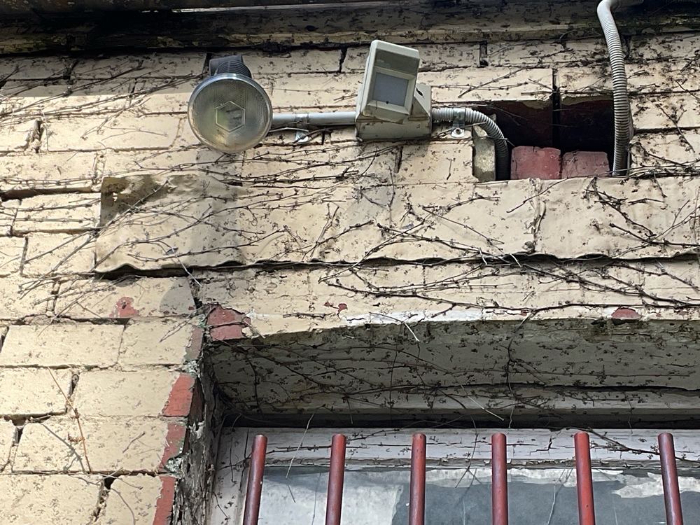Flashing sitting on the brick face instead of recessed into the joint, found during a defect investigation inspection in Richmond