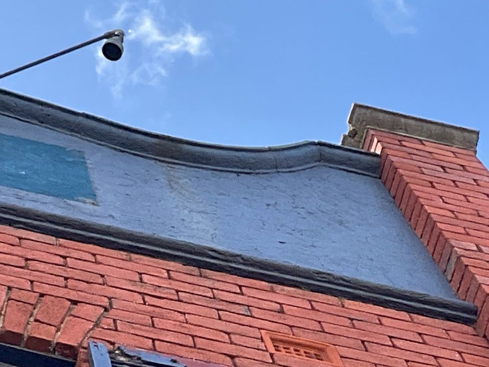 Severe cracking through the front feature stonework, a potential safety hazard, found during a defect investigation inspection in Richmond