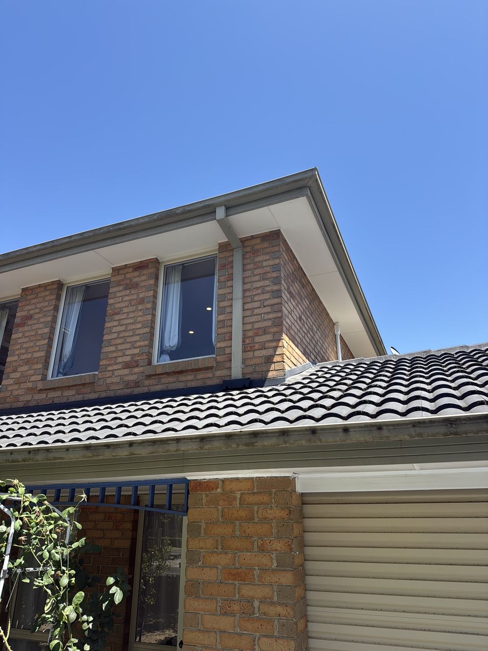 Downpipe spreader discharging straight onto roof flashing, found during a pre-purchase inspection in Wantirna South