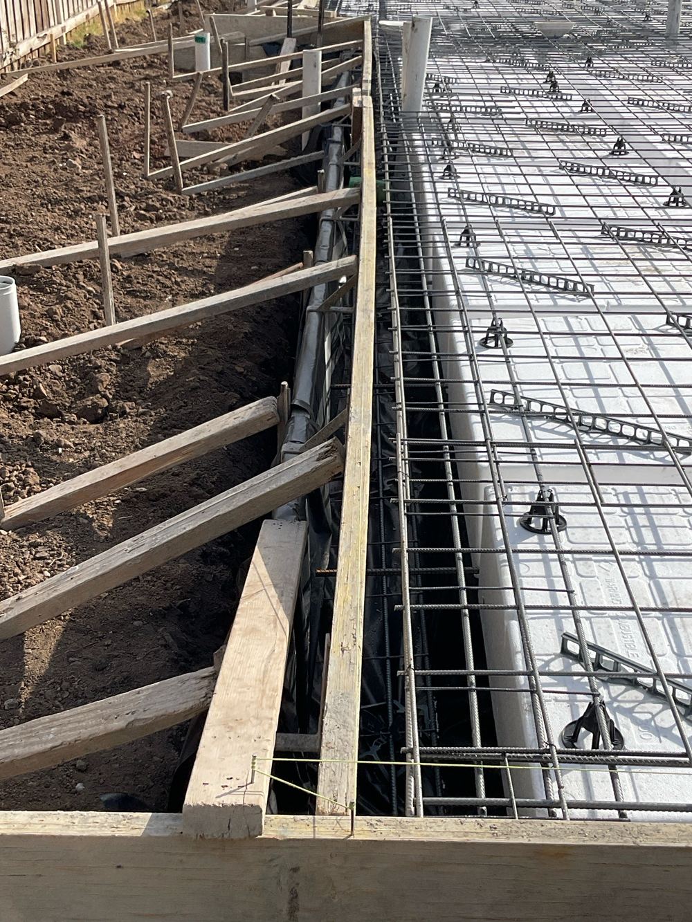 Formwork boards out of line and needing extra bracing, found during a slab pre-pour inspection in Altona North